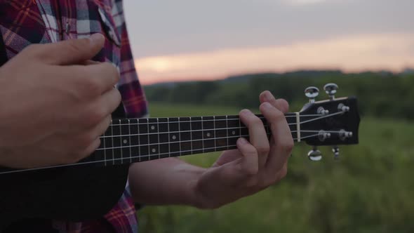 Close Up Moves of Boy's Hand on Giutar's Stripes alt