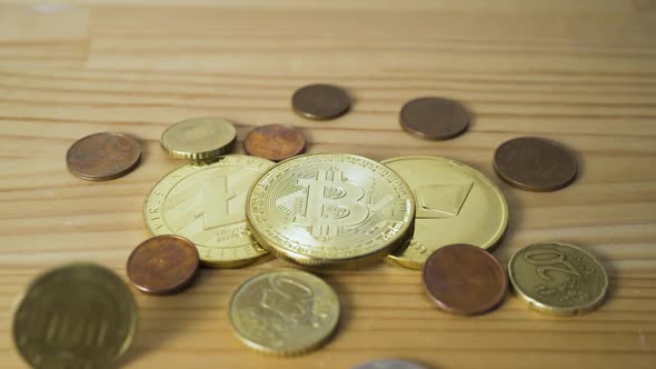 Euro Coins Falling on a Physical Bitcoin, Litecoin and Ethereum from Above in Slow Motion.