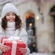 A Woman is Standing in a Snowcovered Square of the City - VideoHive Item for Sale