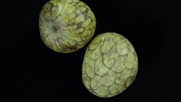 Rotating Exotic Fruit Cherimoya On A Black Background.