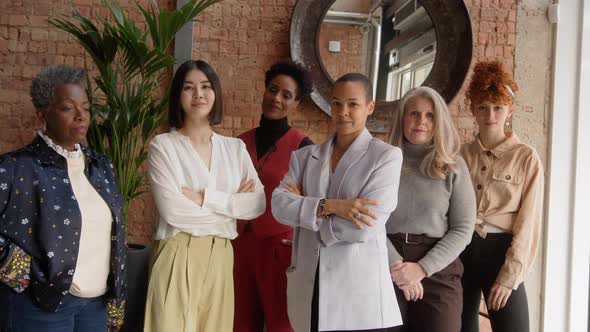Slow motion of multi ethnic mixed age range businesswomen supporting International Women's Day