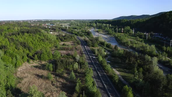 Aerial View Of Vehicles Driving The Road In Prahova Valley Near Campina, Romania. alt