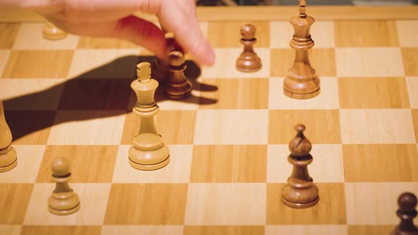 The hands of two chess players move the pieces alternately, taking some chess pieces off the chess b alt