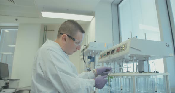Scientist working in a pharmaceutical laboratory conducting experiments alt