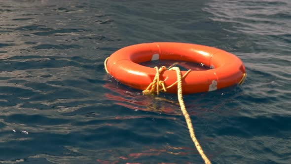 a Lifebuoy Sways on the Waves in the Sea, Serves To Save People Who Have Fallen Into the Water alt