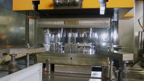 A large industrial punch press forming high precision metal parts for ...