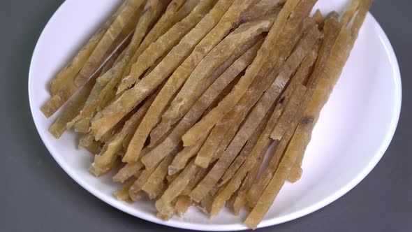 Dried Fish Fillet Cut Into Strips Rotates in a Circle