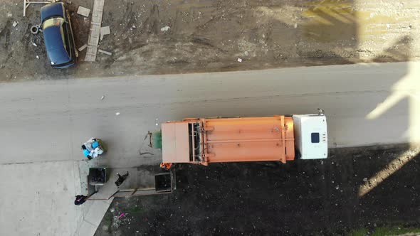 Aerial view, footage of putting recycling waste into a garbage truck. alt
