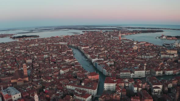 Cinematic descending slider drone shot over Venice at pink hour alt