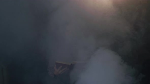 Young Attractive Caucasian Woman Holds a Book and Reads It and Then Gets Up From the Sofa Continuing alt