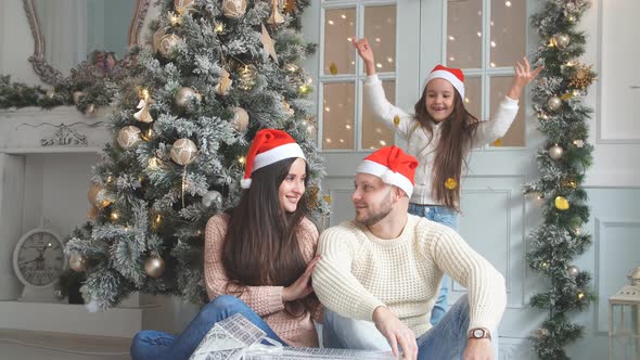 Christmas Photo of a Happy Family Around a Decorated Christmas Tree.