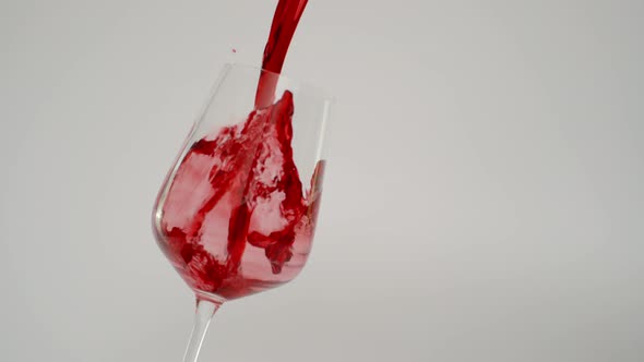 Slow Motion of Red Wine Splashing in Transparent Glass at 1000 Fps alt