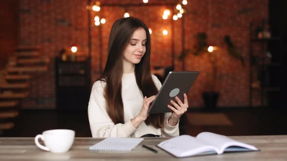 A Woman is Sitting in Her Home Office alt