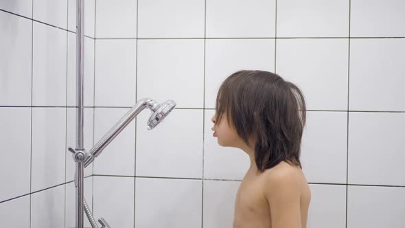 Boy Child 5 Years Old Brunette with Long Hair Washes in the Bathroom and Sings alt