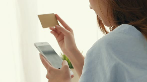 Beautiful woman shopping online with a credit card.