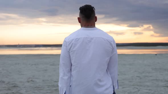 Brutal Man Walking on Beach