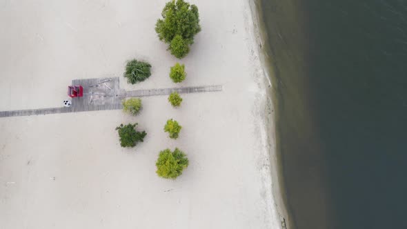 A Sparsely Populated White Sand Beach Surrounded By Trees and Clear Waters of the Dnieper River alt