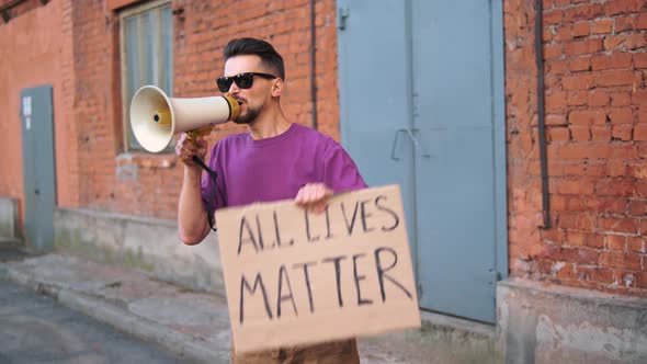 Caucasian Man are Protesting in the Street with Megaphones and Signs