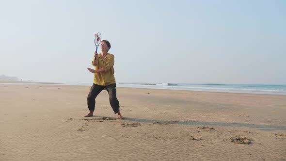 Senior Woman Practicing Tai Chi Balloon Ball on the Beach alt