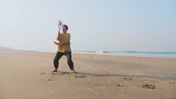 Senior Woman Practicing Tai Chi Balloon Ball on the Beach