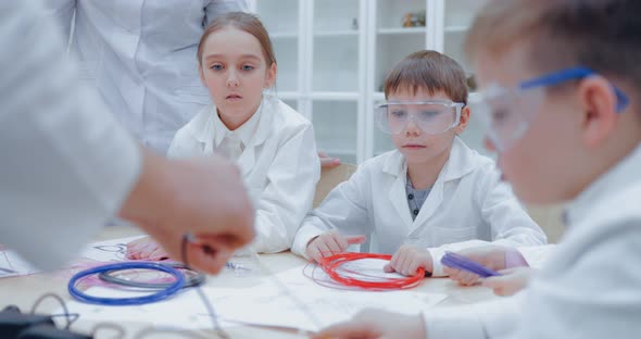 Teacher Prepares the 3d Pen for Work Refills the Plastic in the 3d Pen alt