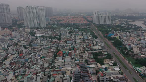 Foggy,smoggy early morning drone footage over urban high-rise and housing developments in district s alt