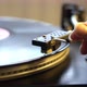 Female Hand Putting Stylus on the Vinyl Record on DJ Turntable Record Player Close Up. The Rotating - VideoHive Item for Sale