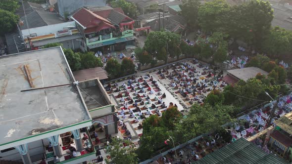Aerial View of People offering prayers on the Eid morning at famous mosque Jama Masjid in Bekasi. alt
