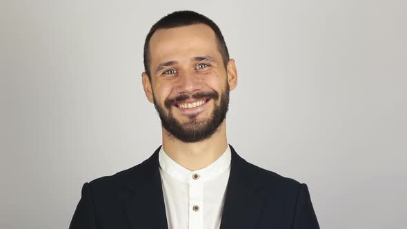 Young Successful Businessman Looking at the Camera and Smiling. Young Bearded Businessman Smiling