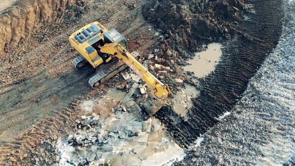 Digging Vehicle Is Grabbing and Relocating Soil at the Quarry Building, Construction Process. alt