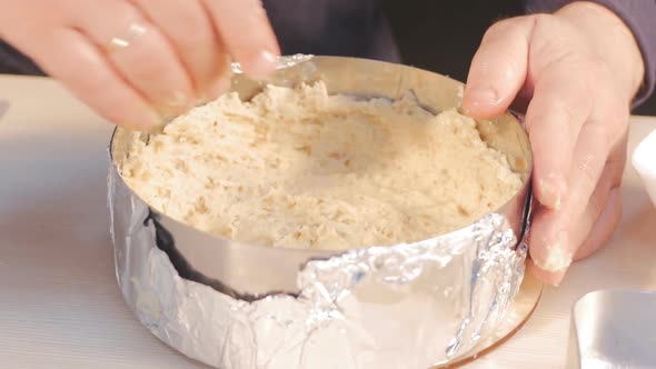the Palm of the Male Confectioner Forms an Indentation of the Dough Inside a Metal Round Ring Mold alt