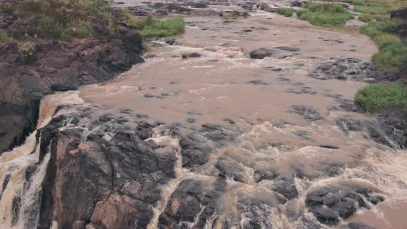 Waterfall in river in Laikipia, Kenya. Aerial drone reveal alt