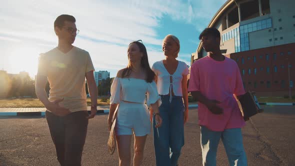 Beauty Difethnic Young Students Walking on Sunny Street Communicating Sharing Stories Laughing alt