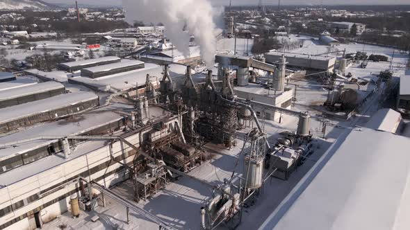 Drone Backward Flies Over the Industrial Area Close to Factory Aerial  Footage alt