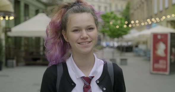 Teenager Girl in School Uniform with Backpack Walking and Smiling alt