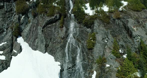 Flying Up Large Spring Waterfall Aerial Snowy Mountain Natural Environment alt