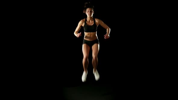 Young Athletic Woman Wearing Sporstwear is Jumping Slow Motion