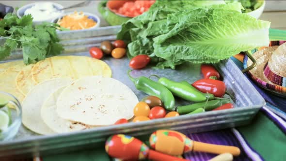 Ground beef tacos with romaine lettuce, diced tomatoes, radishes, and shredded cheddar cheese. alt