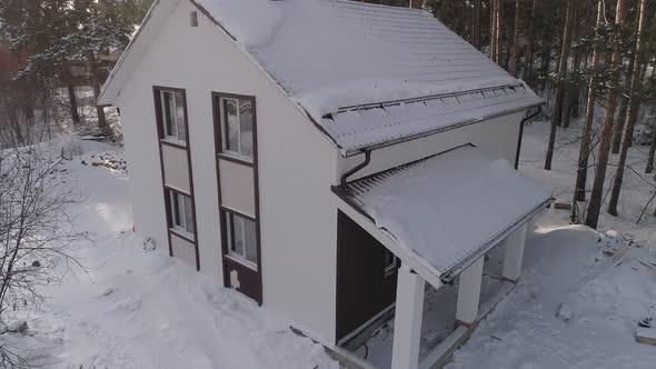 Drone shot of new white modern residential house at winter near the forest 06 alt