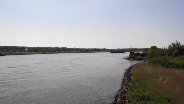 Distant View Of Crude Oil Tanker Sailing On River. wide shot alt