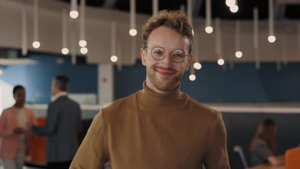 Portrait of Confident Young Businessman in Stylish Clothes Looking at Camera While Standing Indoors alt