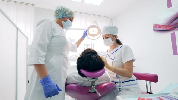 A Patient is Having Her Teeth Treated By Doctors alt