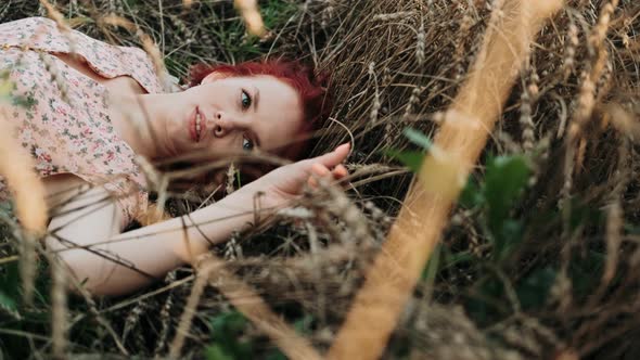 Closeup Face of Beautiful Girl Lying on the Grass alt