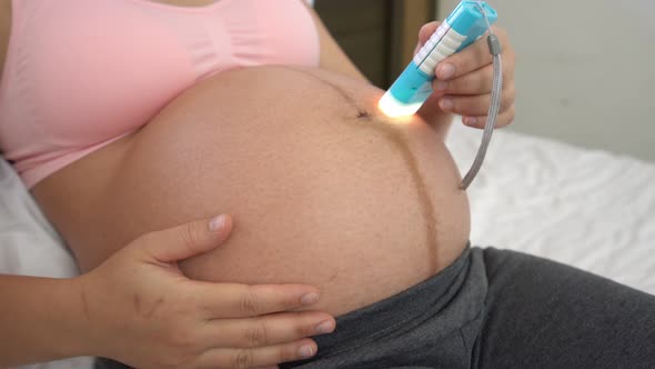 Happy Pregnant Woman and Expecting Baby at Home alt