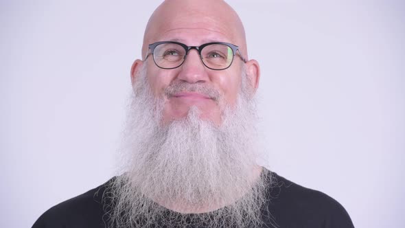 Face of Mature Bald Bearded Man Looking Bored and Frustrated alt