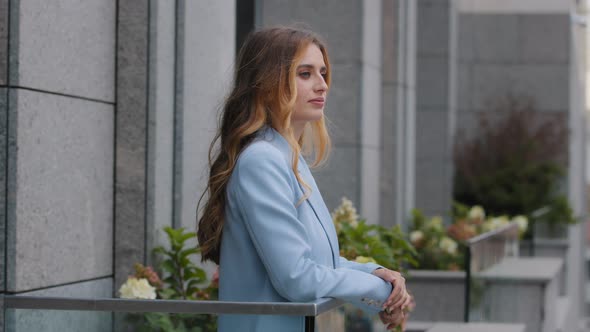 Attractive Stylish Beautiful Young Business Woman Boss Female Leader Girl in Trendy Blue Suit Stands alt