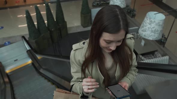 The Brownhaired Woman Rides the Escalator alt