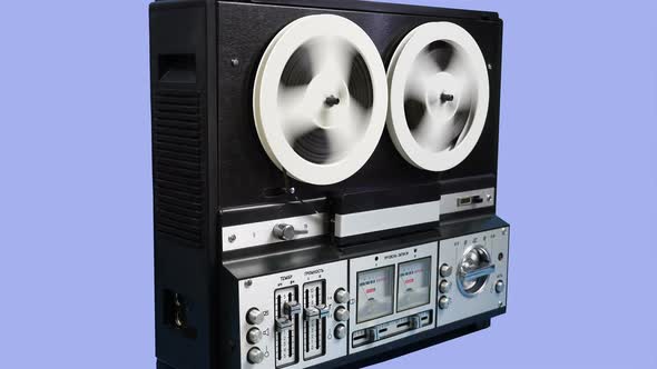Rewinding Tape On An Old Reel To Reel Recorder On A Blue Background 1.