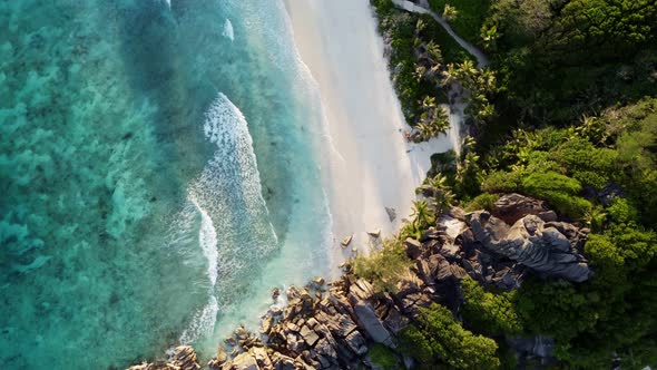 beach with azure water and large stones