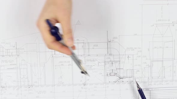 Architects Are Sitting at the Table Analyzing the Drawing. Close Up alt